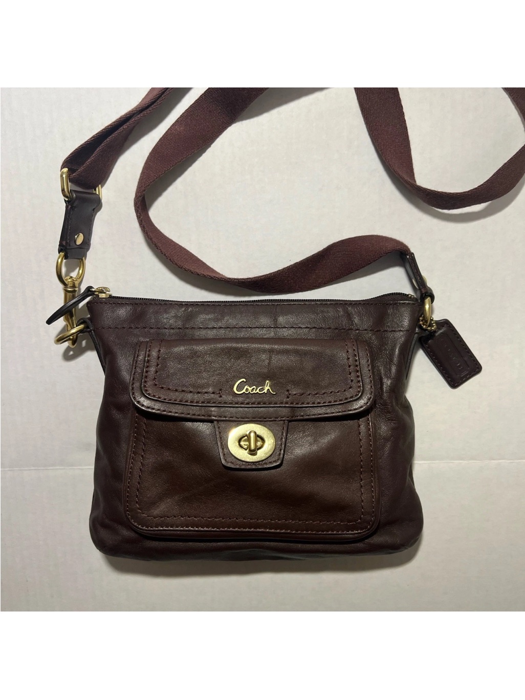Coach Penelope Turn-Lock Swingpack Crossbody Bag In Brown Leather